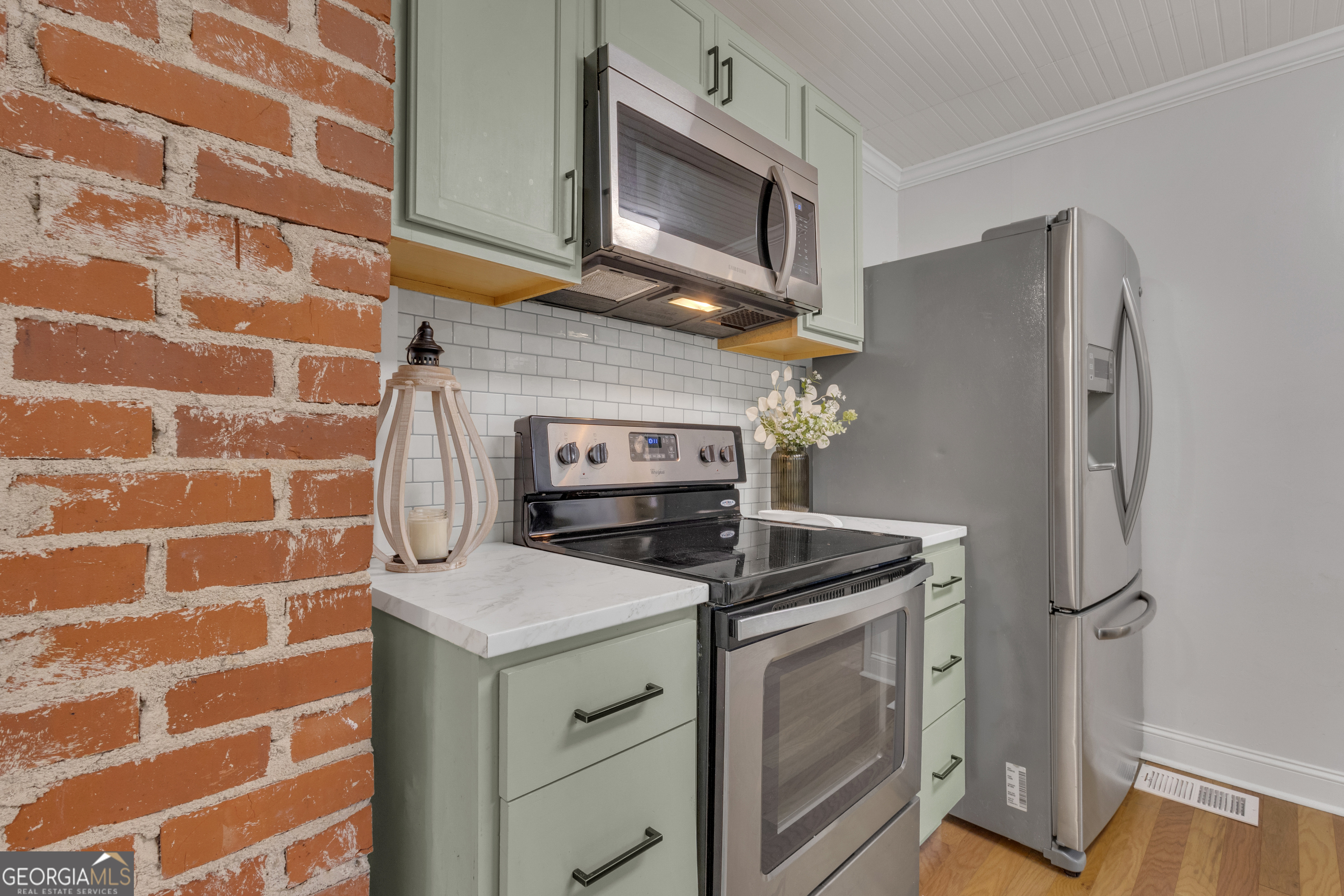 9 Meridian Drive Newnan, GA 30263 - Photo 12 of 42 a kitchen with stainless steel appliances granite countertop cabinets a washer and dryer