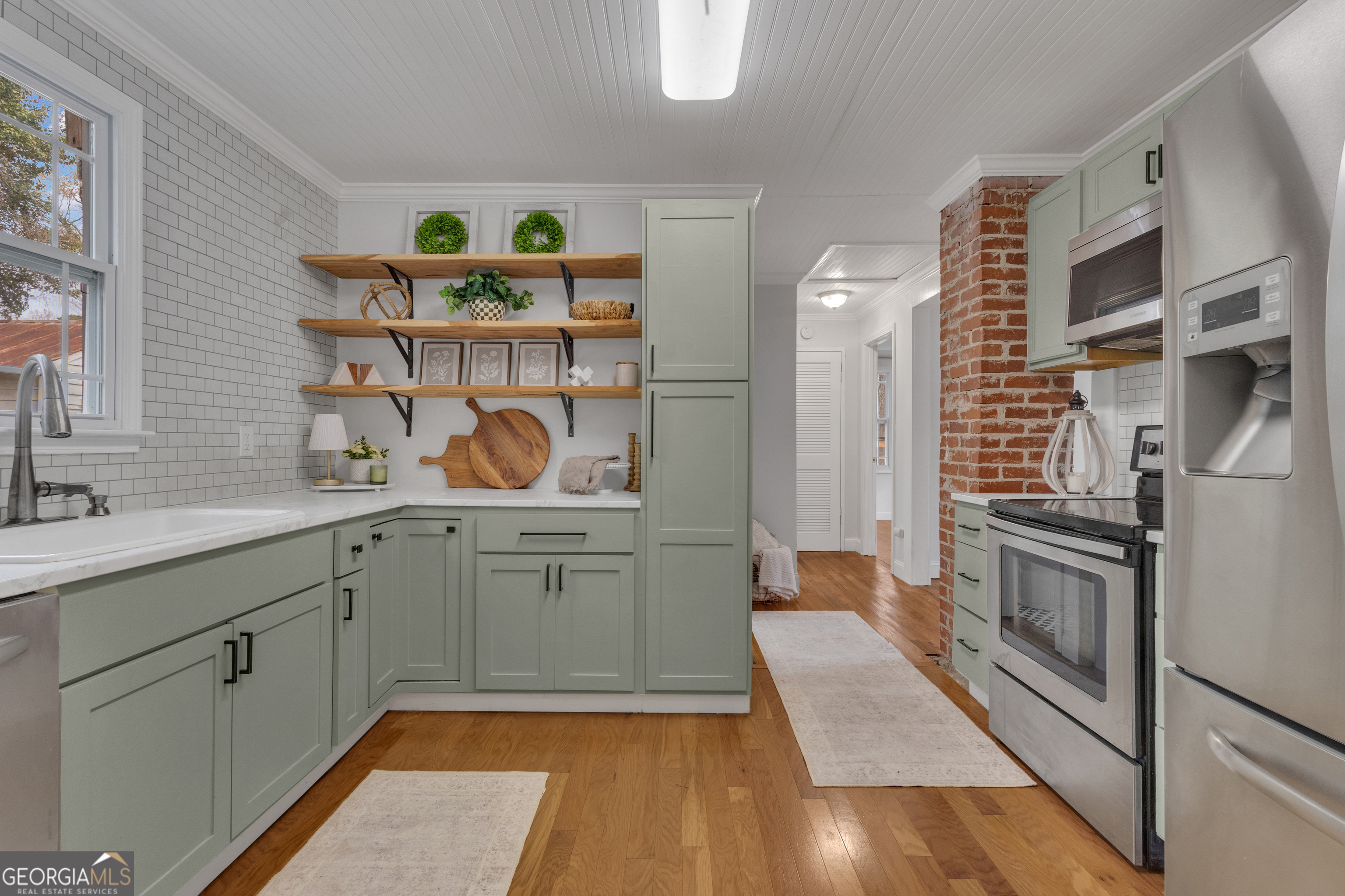 9 Meridian Drive Newnan, GA 30263 - Photo 15 of 42 a kitchen with stainless steel appliances granite countertop a stove a sink and a refrigerator