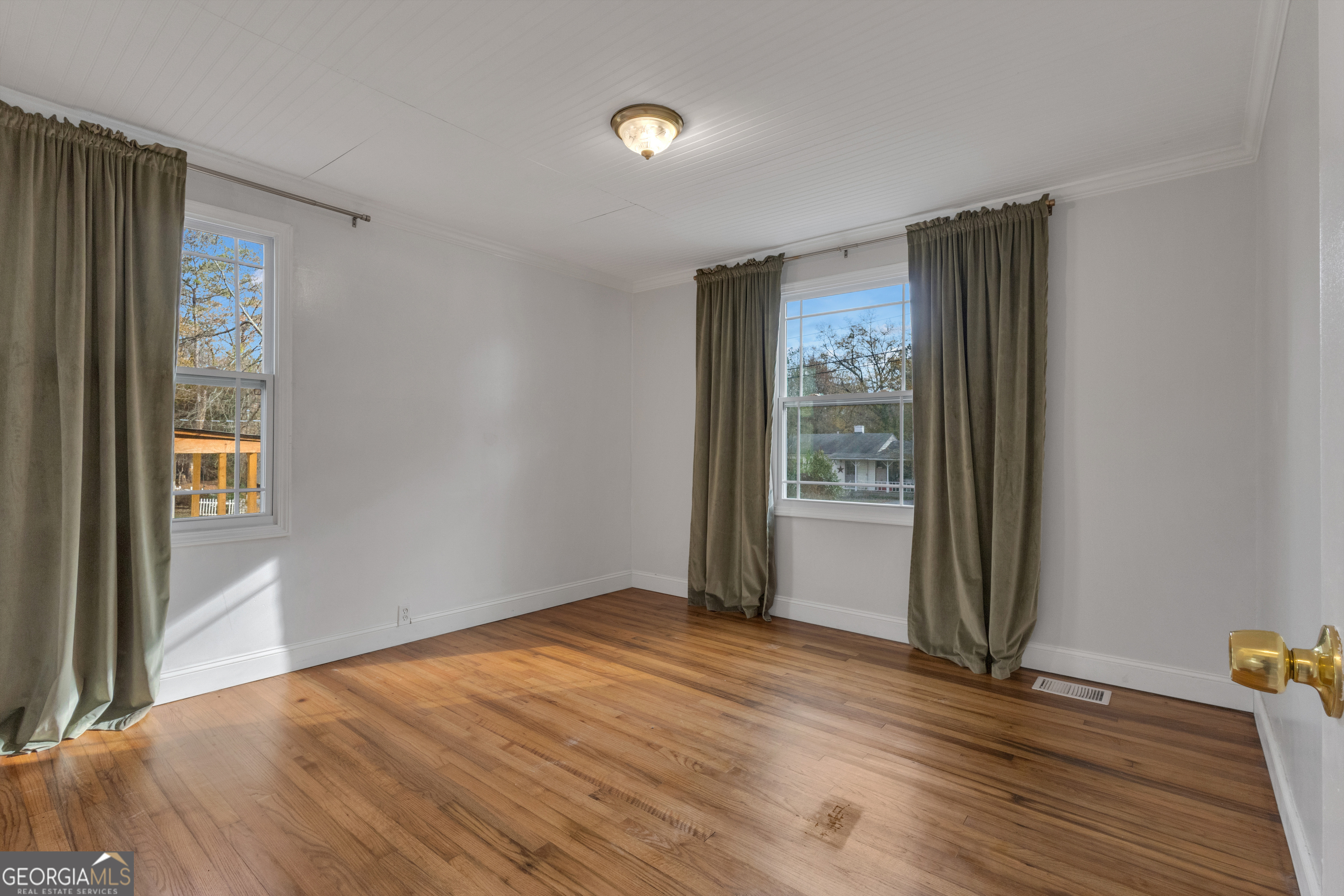9 Meridian Drive Newnan, GA 30263 - Photo 20 of 42 a view of an empty room with wooden floor and a window