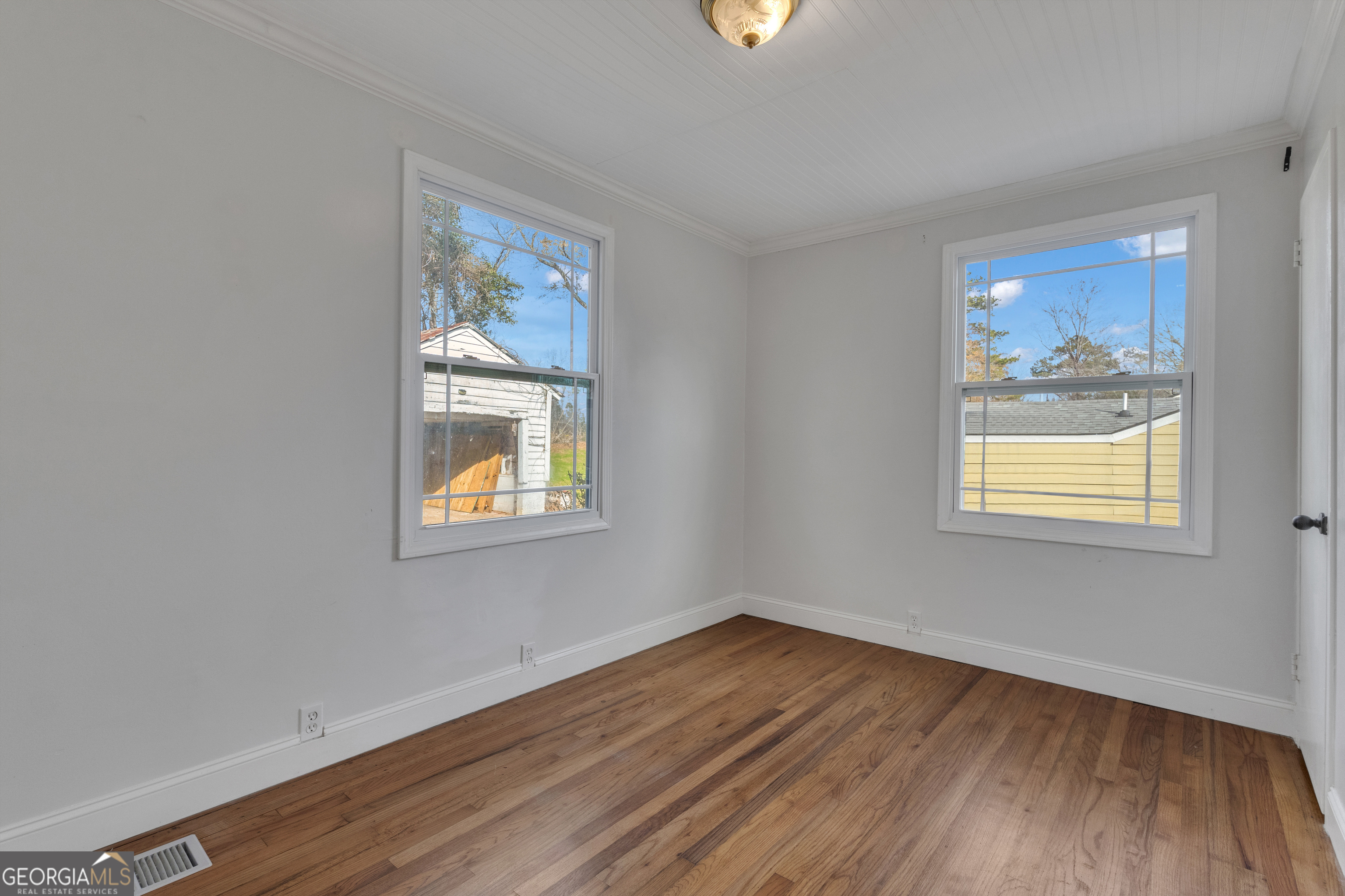 9 Meridian Drive Newnan, GA 30263 - Photo 24 of 42 a view of an empty room with wooden floor and a window