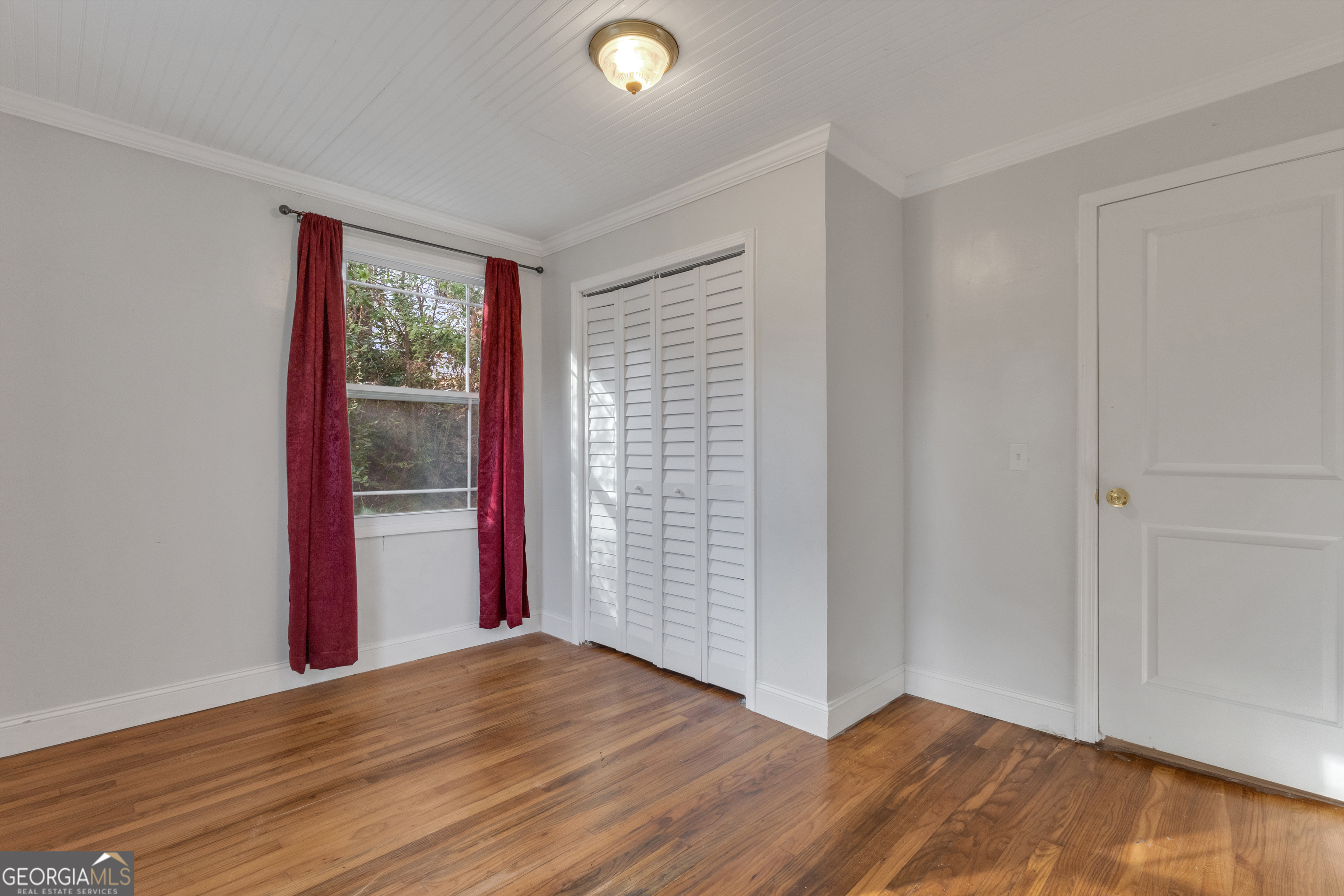 9 Meridian Drive Newnan, GA 30263 - Photo 29 of 42 a view of an empty room with wooden floor and a window