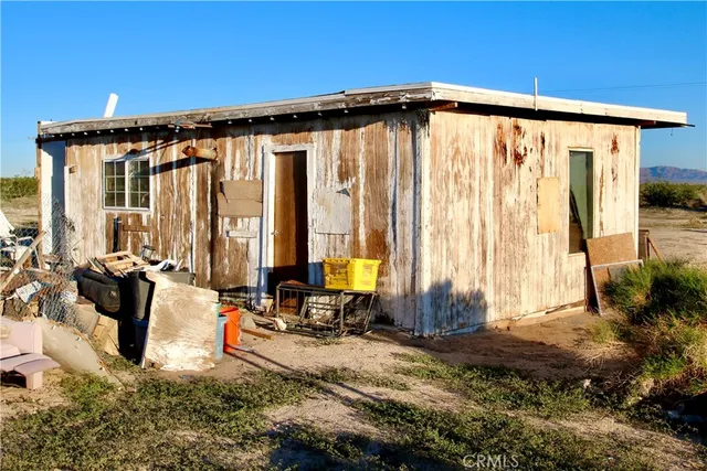a view of back yard with patio