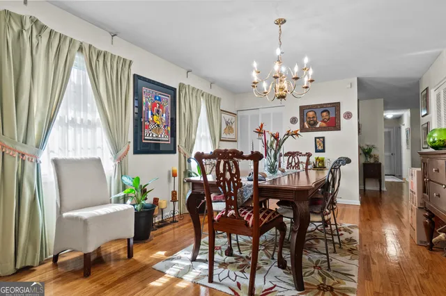 a living room with furniture a large window and a flat screen tv
