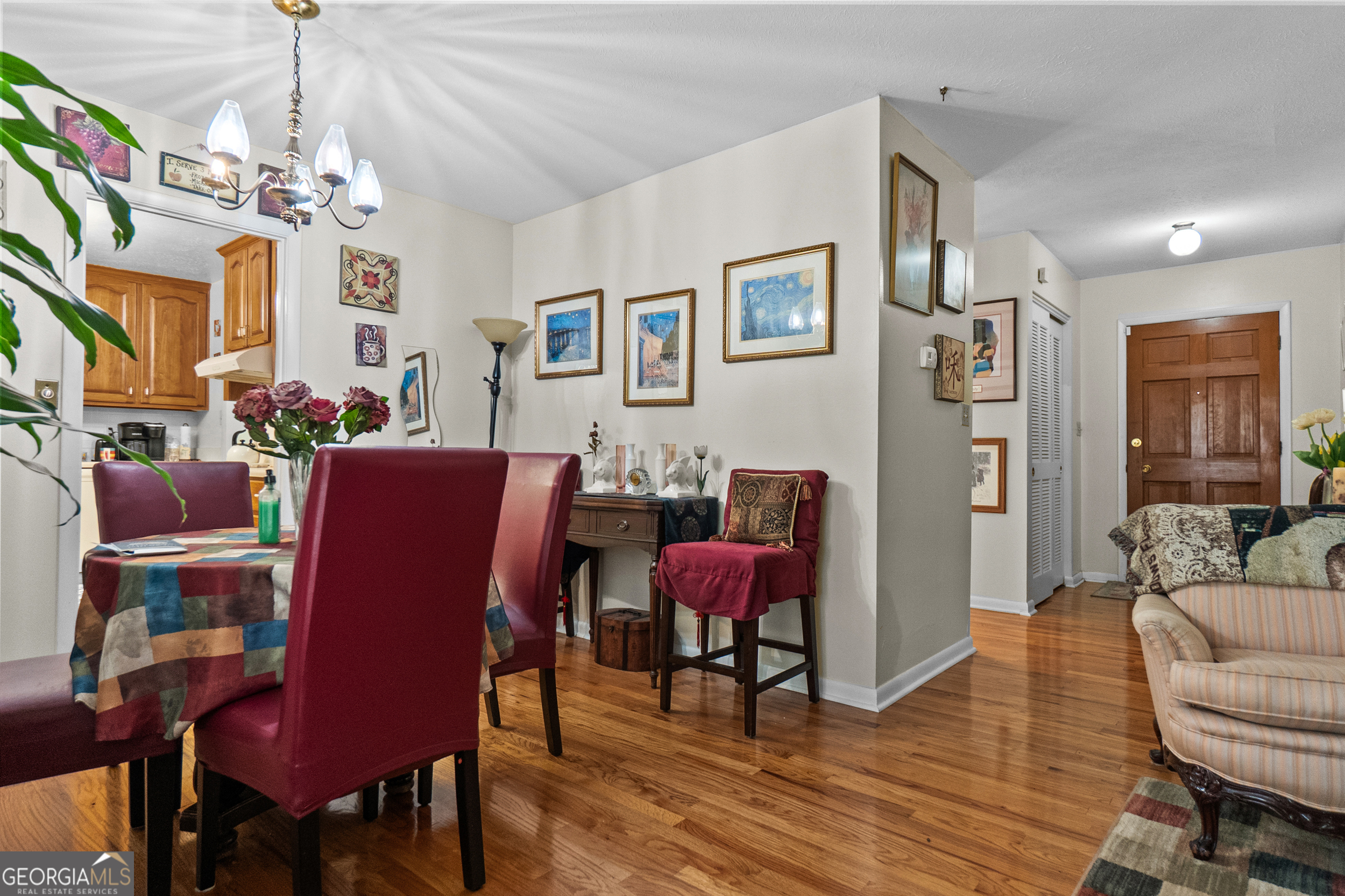 2101 Goldendale Lane Albany, GA 31721 - Photo 25 of 59 a view of a dining room with furniture a chandelier and wooden floor