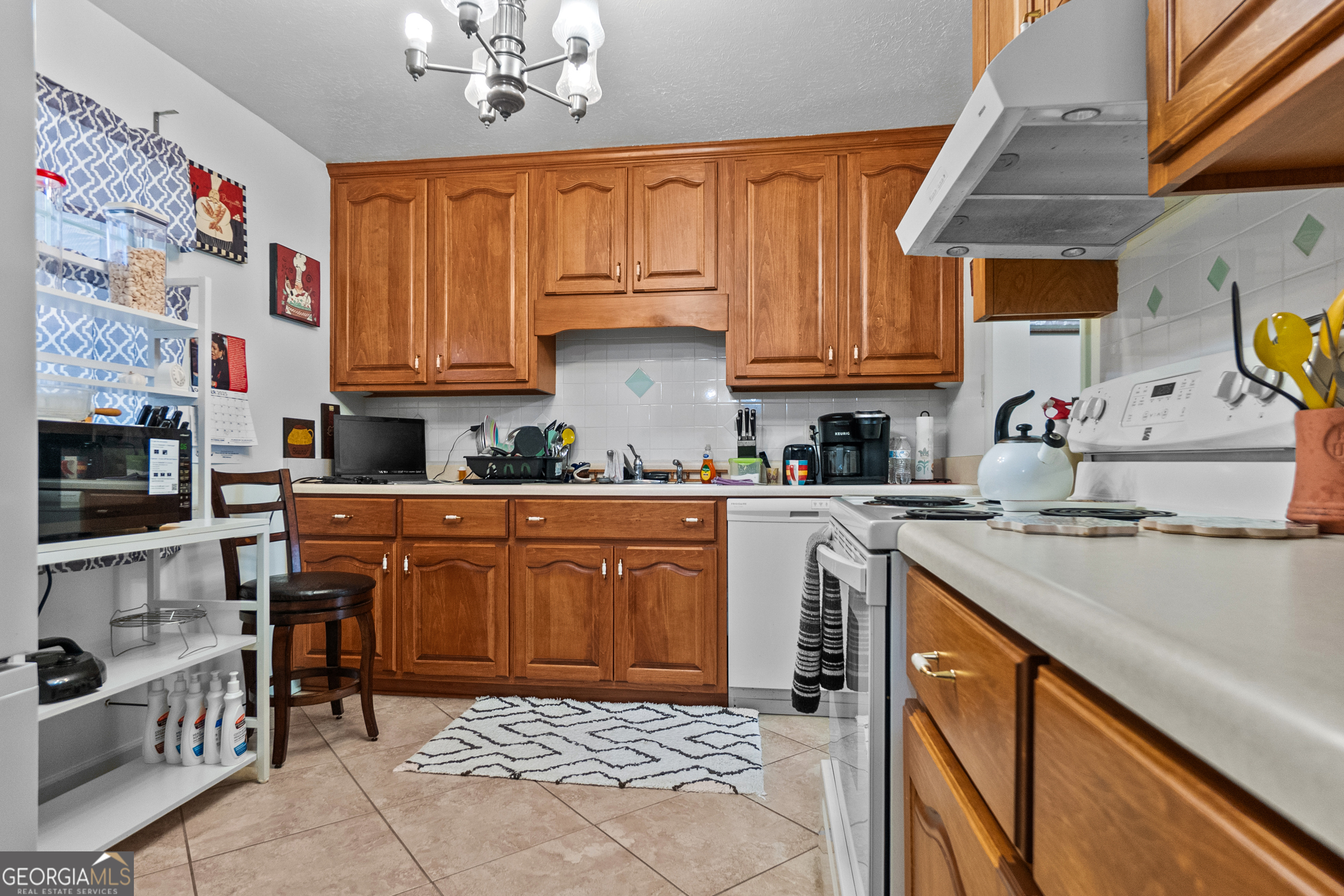 2101 Goldendale Lane Albany, GA 31721 - Photo 31 of 59 a kitchen with stainless steel appliances granite countertop a stove a sink dishwasher and cabinets with wooden floor