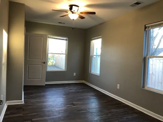 a view of wooden floor and windows in a room