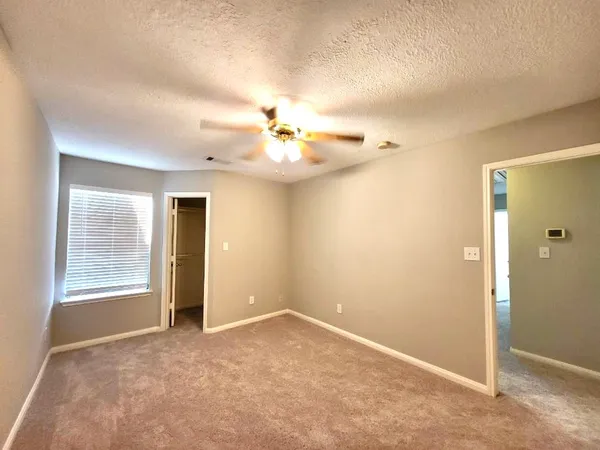 an empty room with windows and entrance