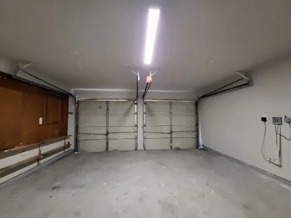 a view of a room with gym equipment and racks on the wall