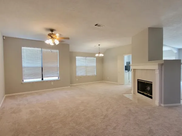 a view of empty room with a fireplace