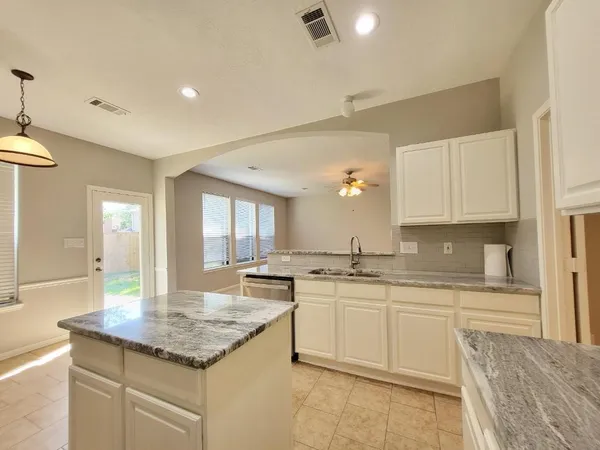a kitchen with stainless steel appliances granite countertop a sink and cabinets