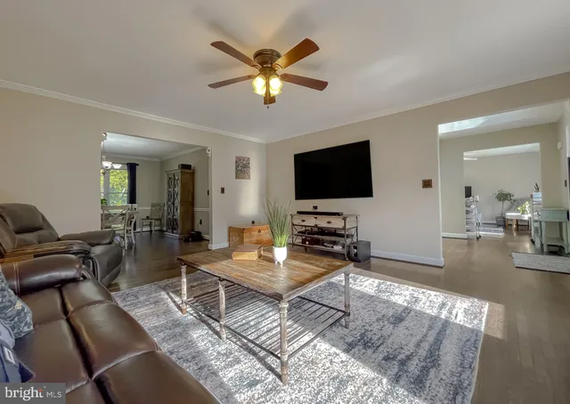 a view of a dining room with furniture a chandelier and wooden floor