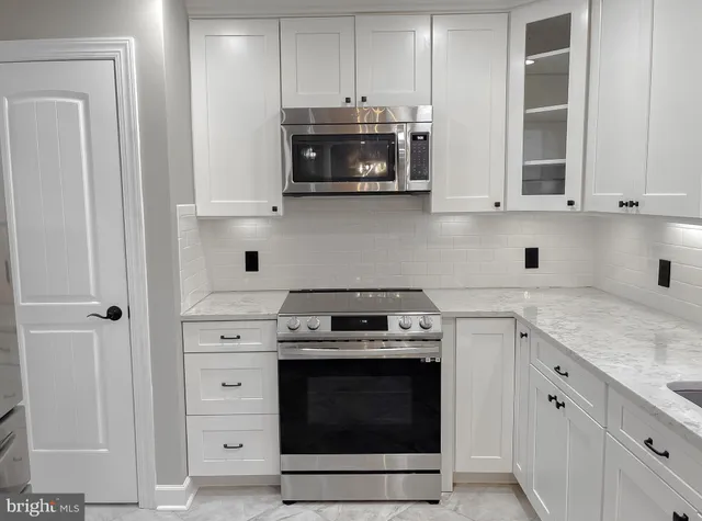 a view of a livingroom with wooden floor and stairs