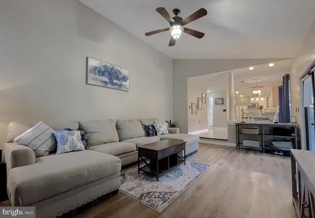 a bedroom with a large bed chandelier and window