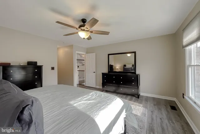 an outdoor sitting area with furniture and umbrella