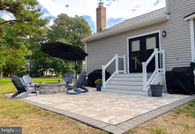 a front view of a house with a yard and potted plants