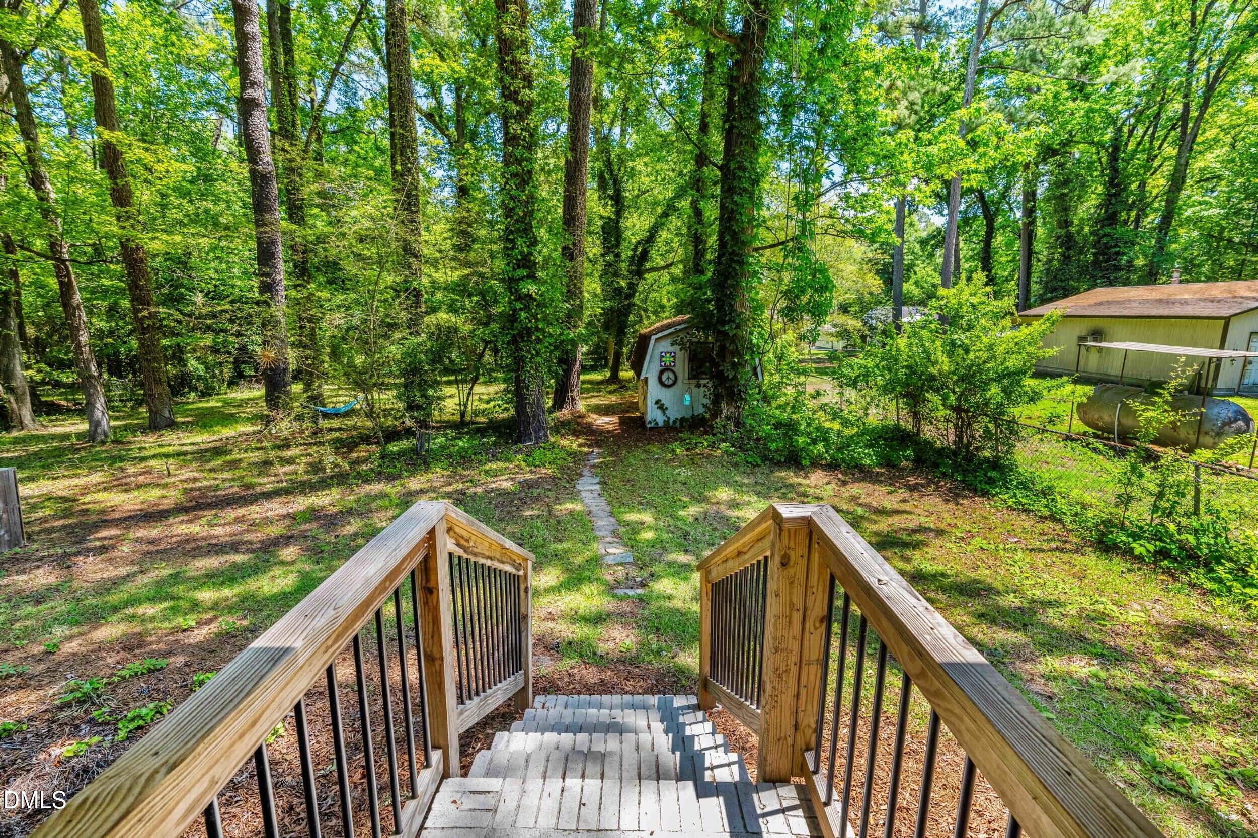 3724 Randell Road Garner, NC 27529 - Photo 26 of 32 a view of a wooden deck and trees with wooden fence
