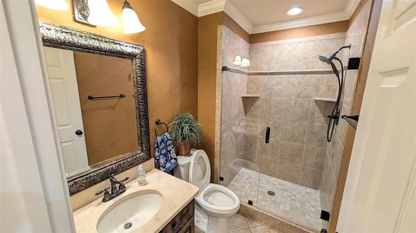 a bathroom with a sink toilet and shower