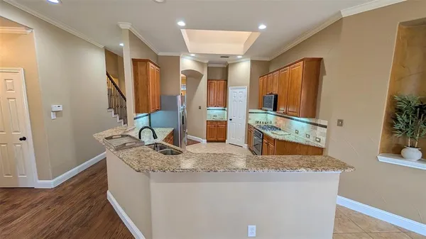 a bathroom with a granite countertop sink a mirror and vanity