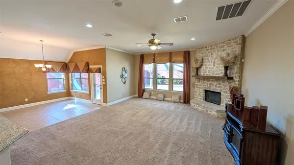 a view of an empty room with a fireplace and a window