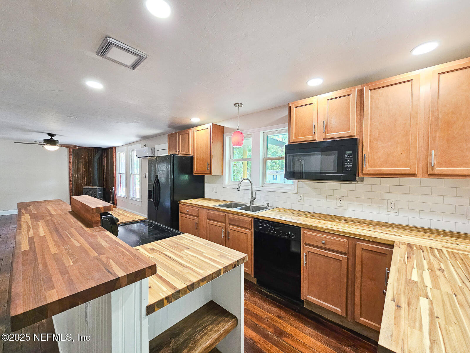 125 Lemon Street, Unit 22 Melrose, FL 32666 - Photo 11 of 28 a kitchen with a sink a counter top space stainless steel appliances and cabinets