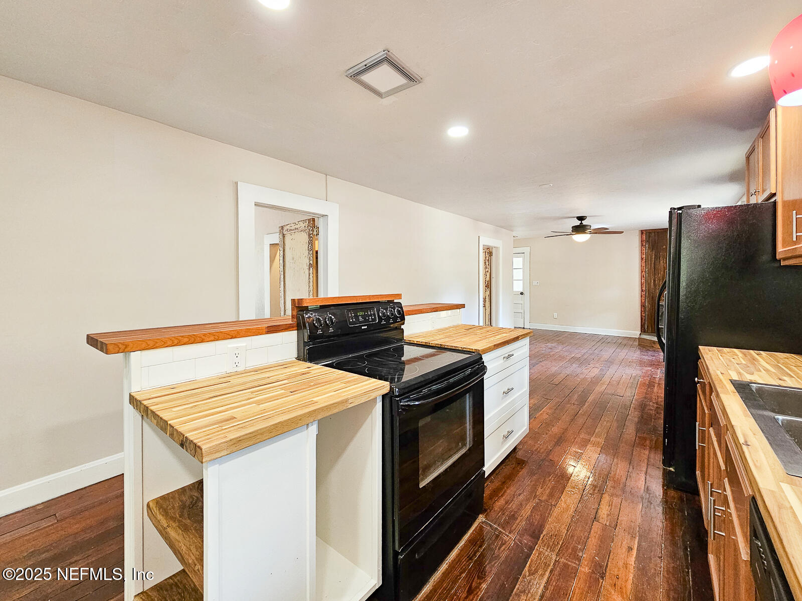 125 Lemon Street, Unit 22 Melrose, FL 32666 - Photo 12 of 28 a kitchen that has a sink and a stove with wooden floor