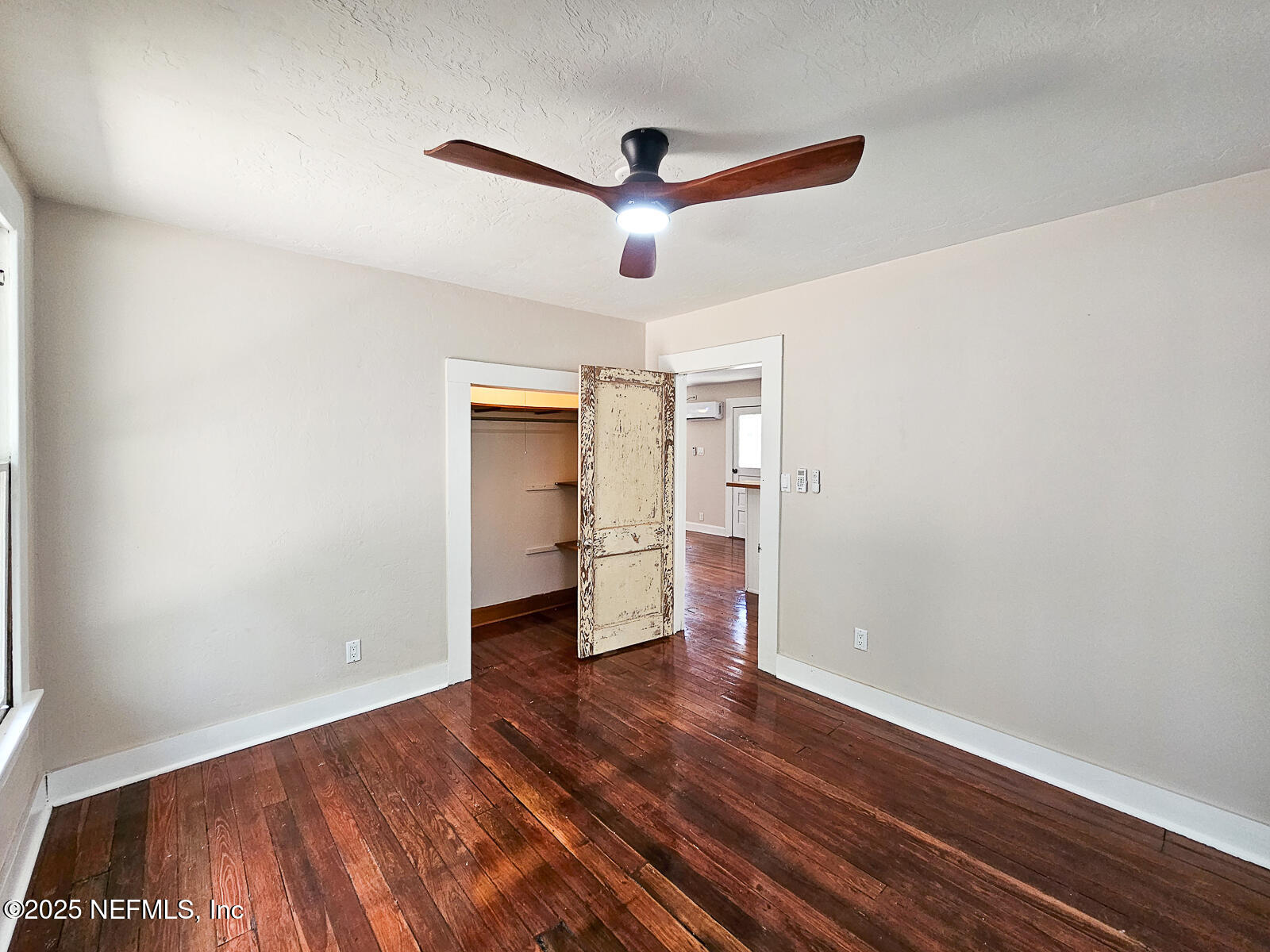 125 Lemon Street, Unit 22 Melrose, FL 32666 - Photo 15 of 28 a view of empty room with wooden floor and ceiling fan