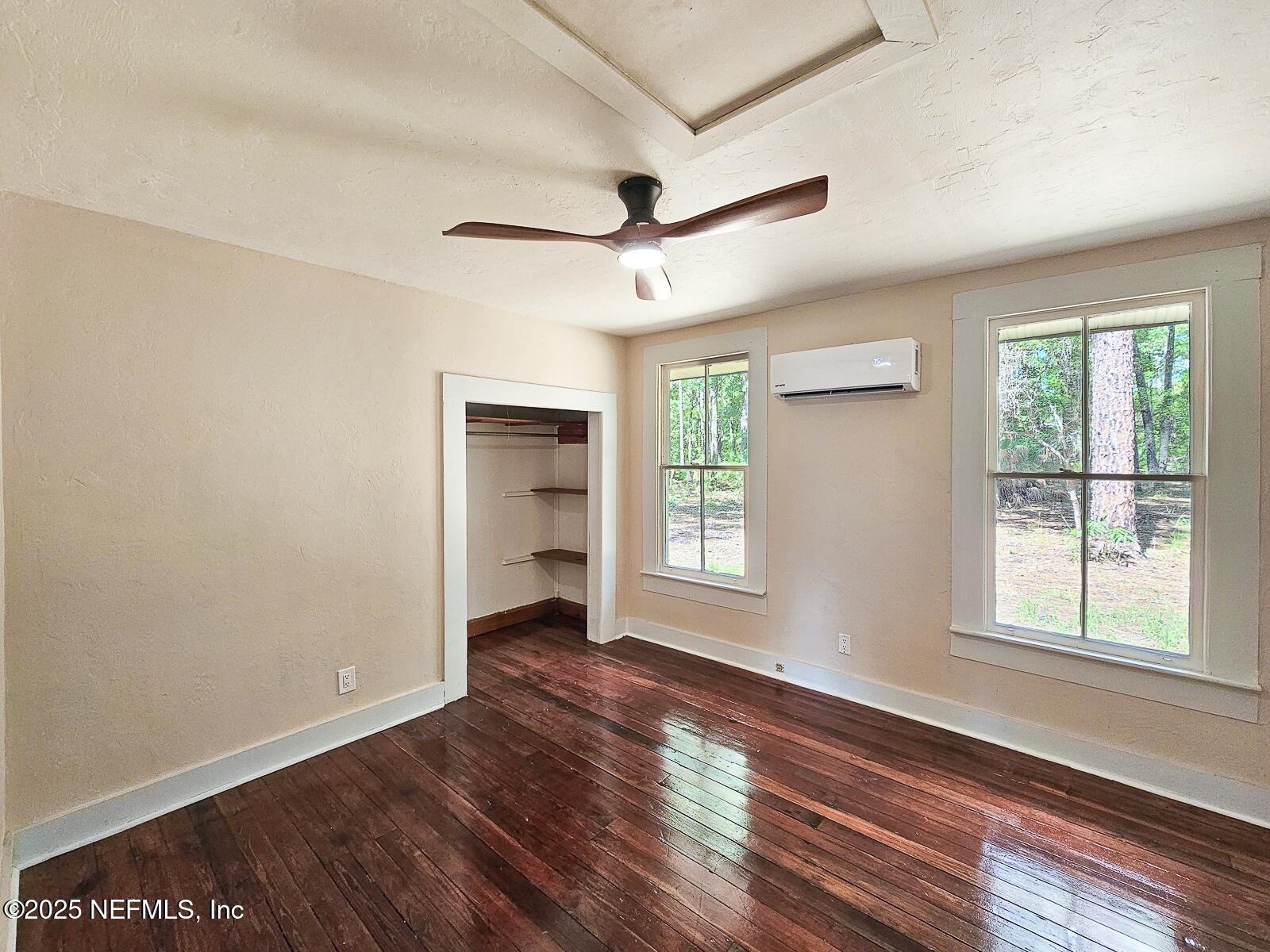125 Lemon Street, Unit 22 Melrose, FL 32666 - Photo 16 of 28 a view of an empty room with a window and wooden floor