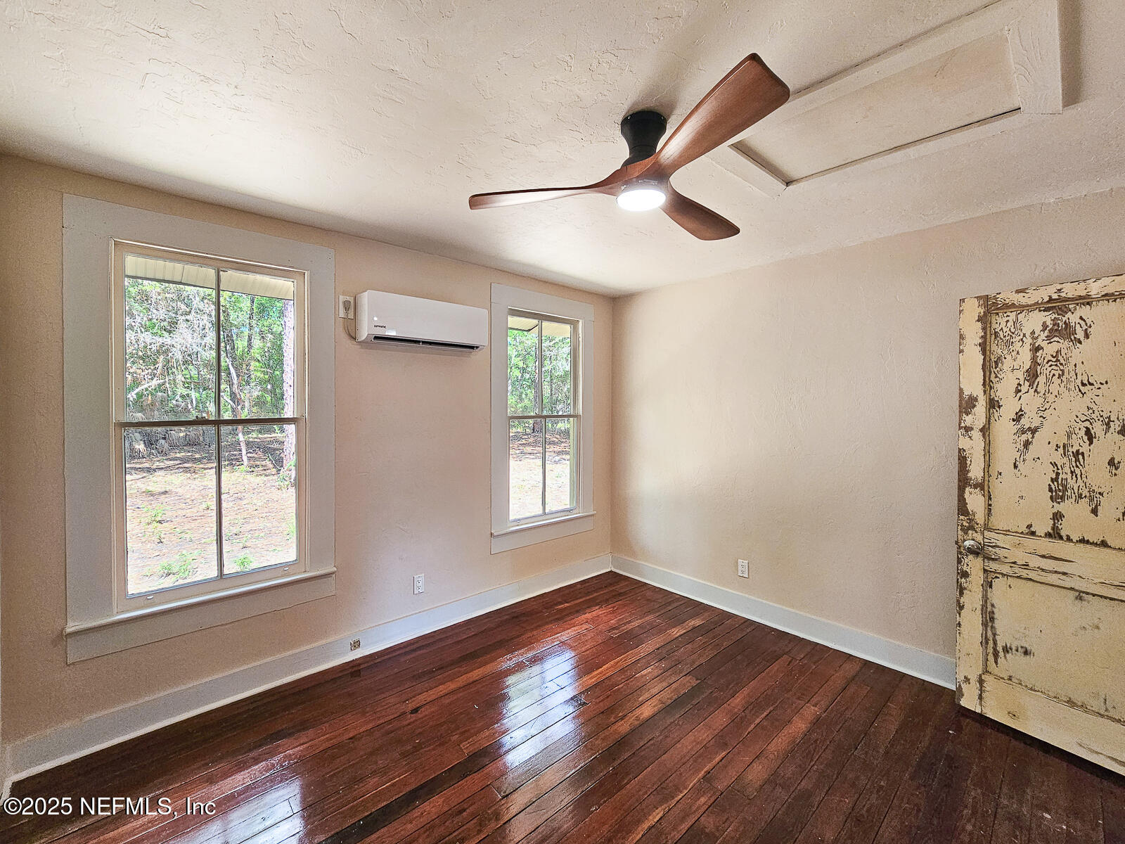 125 Lemon Street, Unit 22 Melrose, FL 32666 - Photo 17 of 28 a view of empty room with wooden floor and fan