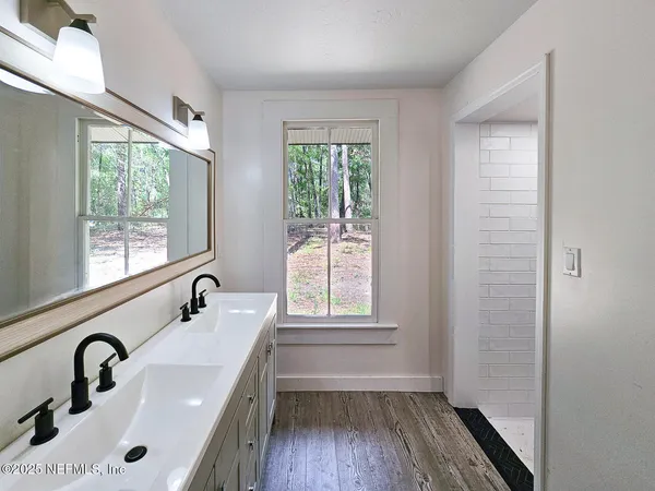 a bathroom with a sink and a window