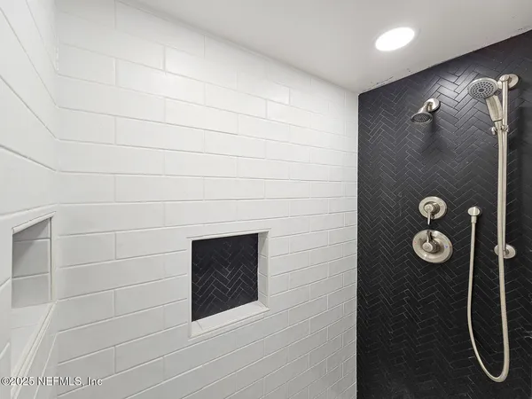 a bathroom with a shower and mirror