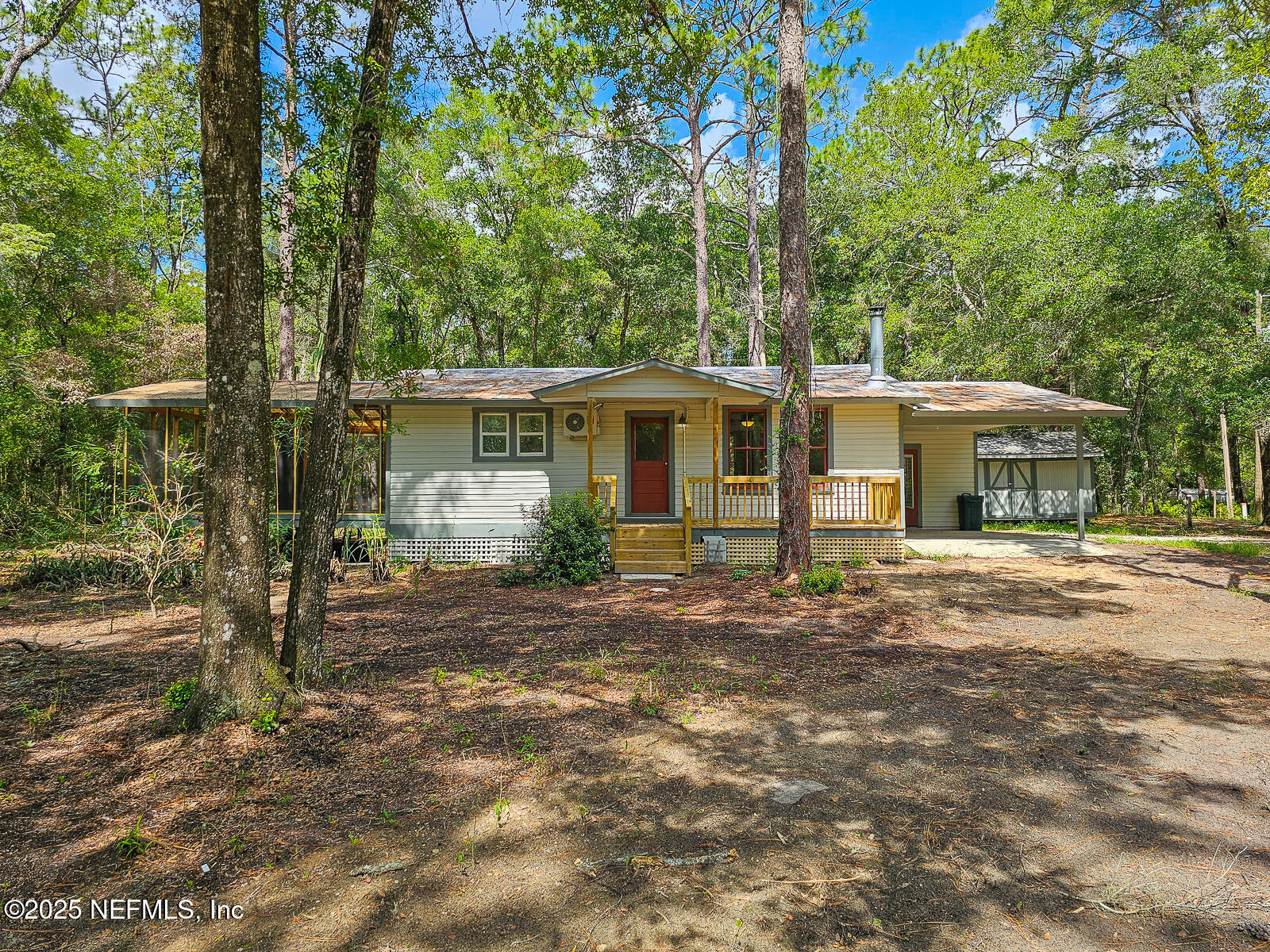 125 Lemon Street, Unit 22 Melrose, FL 32666 - Photo 2 of 28 a front view of a house with a garden