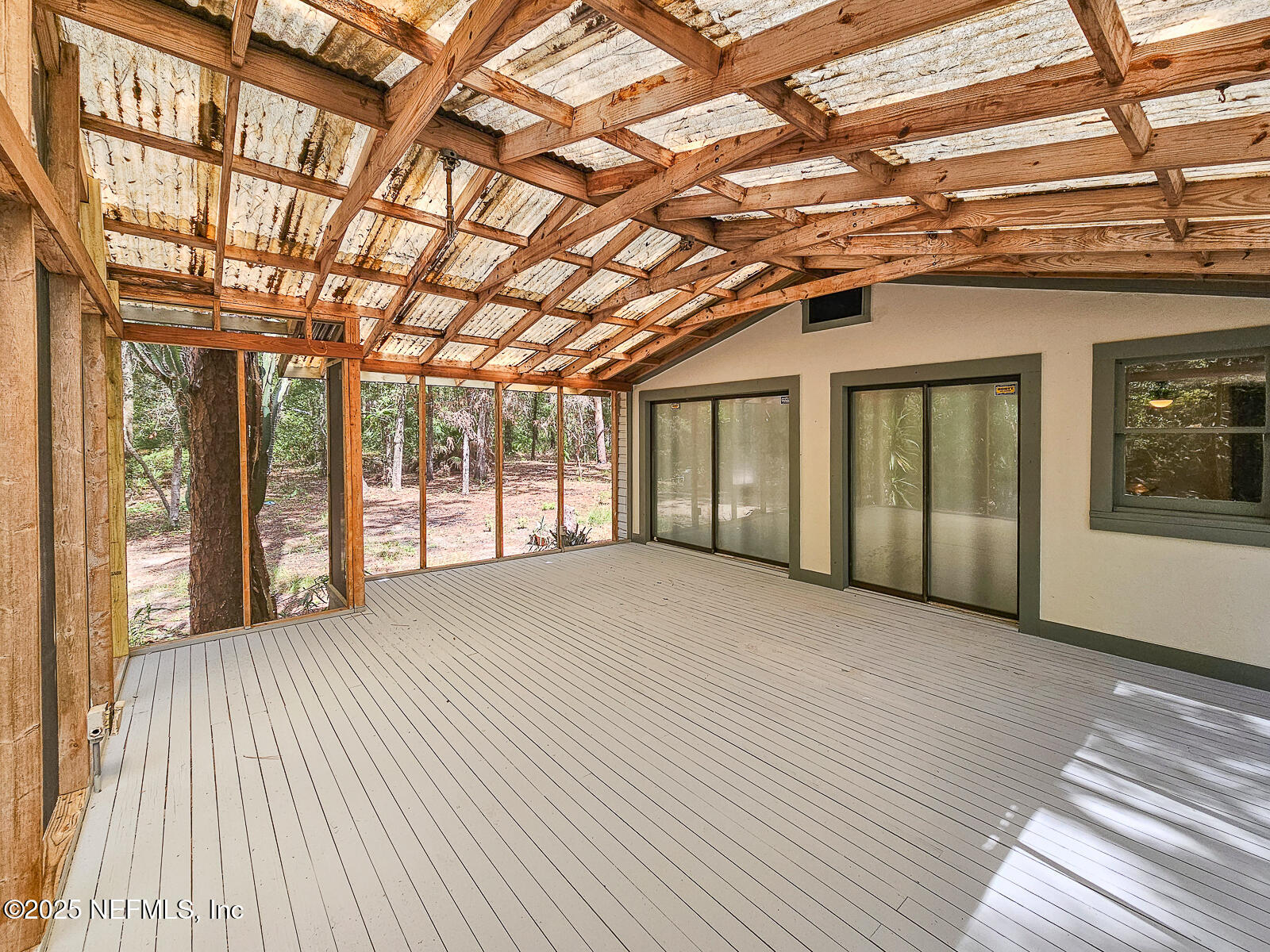 125 Lemon Street, Unit 22 Melrose, FL 32666 - Photo 21 of 28 a view of an empty room with wooden floor and a window