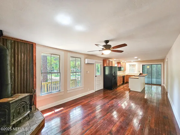 a view of a livingroom with furniture wooden floor and window