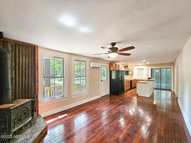 a view of a livingroom with furniture wooden floor and window