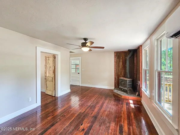 wooden floor in an empty room with a window