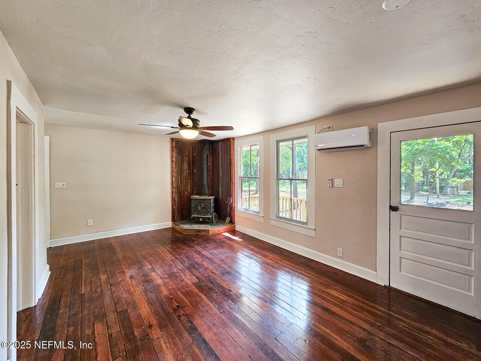 125 Lemon Street, Unit 22 Melrose, FL 32666 - Photo 7 of 28 an empty room with wooden floor and windows