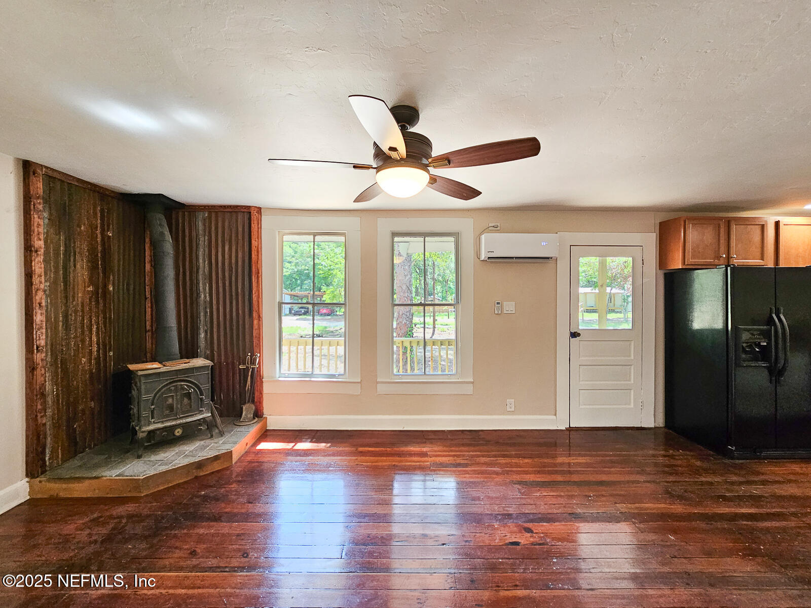 125 Lemon Street, Unit 22 Melrose, FL 32666 - Photo 8 of 28 a view of an empty room with wooden floor and a window