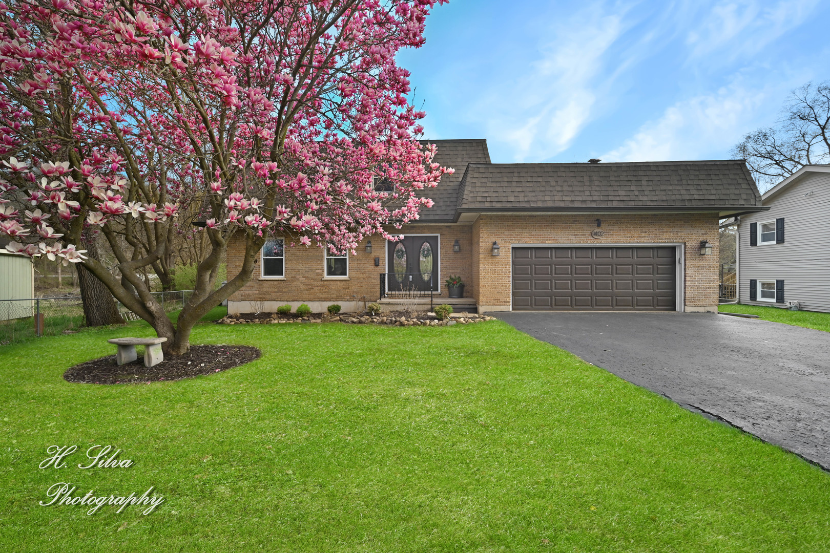 a front view of a house with a garden