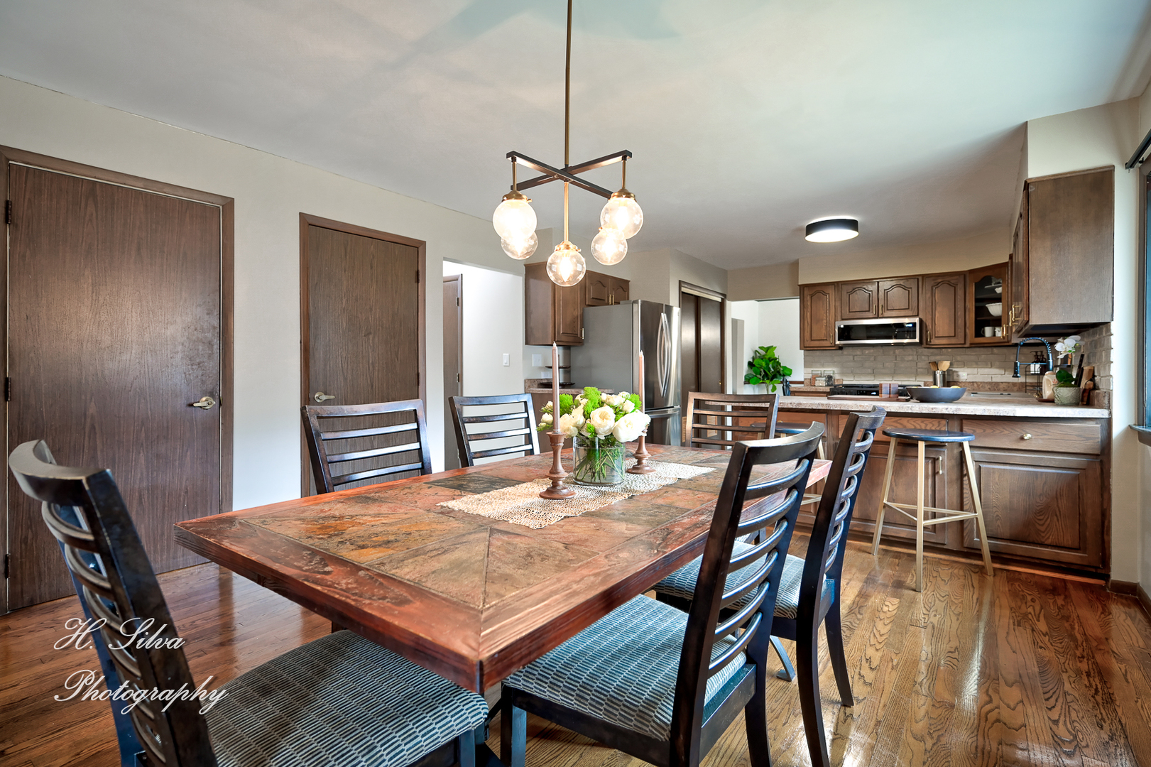 1402 Winaki Trail Algonquin, IL 60102 - Photo 11 of 33 a dining room with a table chairs and kitchen view
