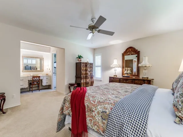 a bedroom with a bed couch and a window