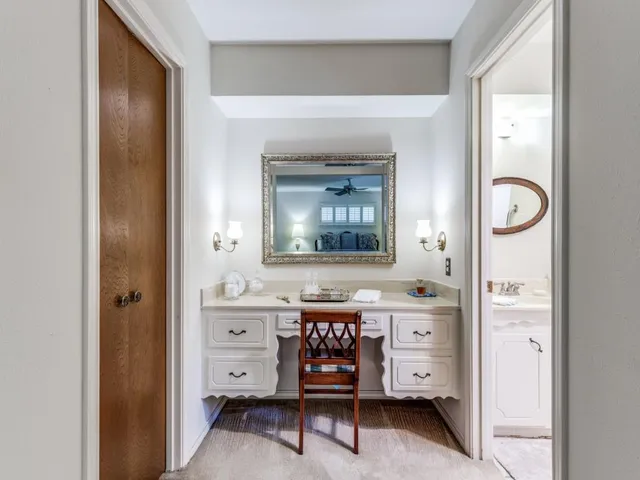 a view of a bedroom with a bed and a mirror