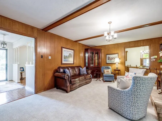 a living room with furniture and a chandelier