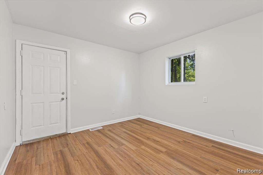 3930 Bayhan Street Inkster, MI 48141 - Photo 12 of 14 Neutral wall color with wood-finish flooring