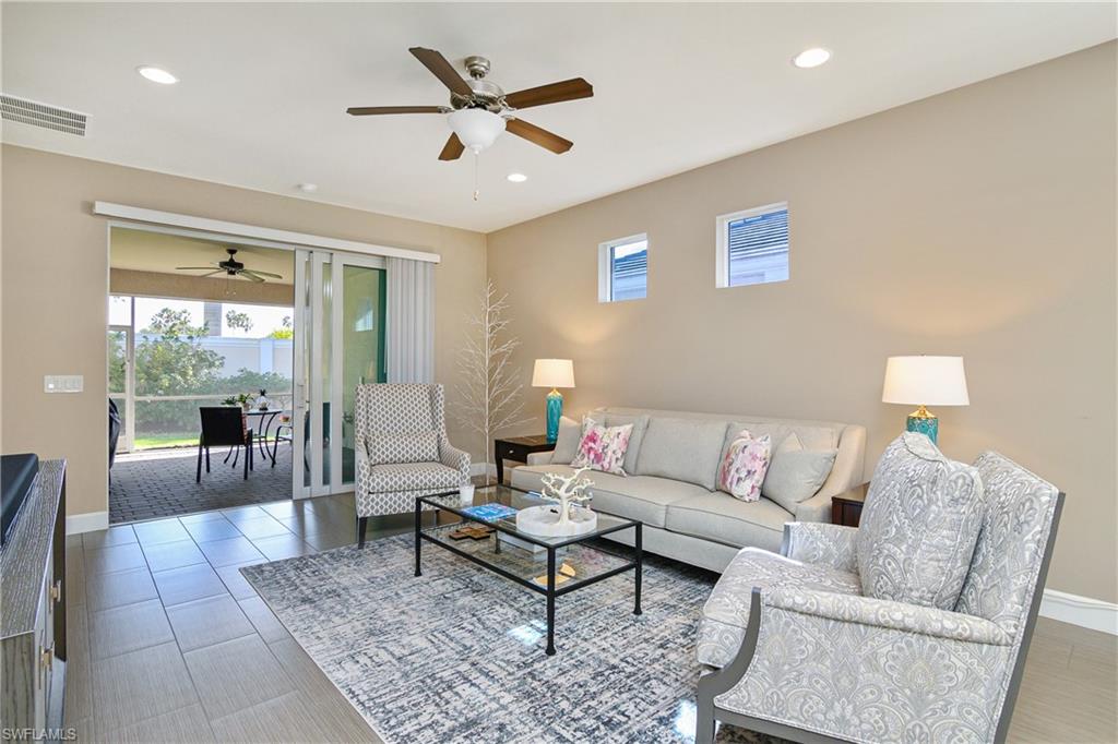 20111 Torch Key Way Estero, FL 33928 - Photo 11 of 29 a living room with furniture and a large window