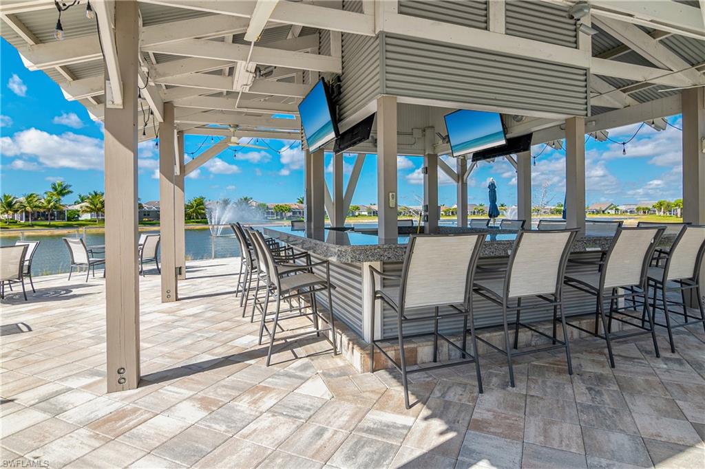 20111 Torch Key Way Estero, FL 33928 - Photo 21 of 29 a view of a patio with dining table and chairs with wooden floor