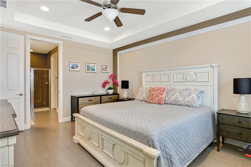 20111 Torch Key Way Estero, FL 33928 - Photo 6 of 29 a bedroom with a bed and a chandelier