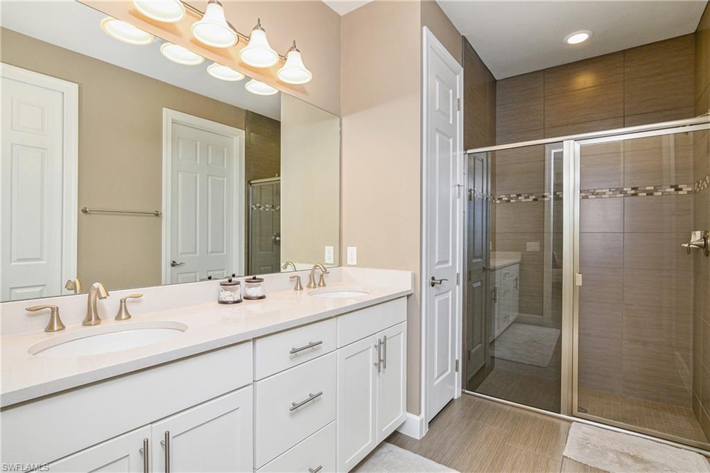 20111 Torch Key Way Estero, FL 33928 - Photo 7 of 29 a bathroom with a double vanity sink mirror and shower