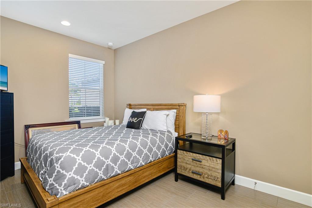 20111 Torch Key Way Estero, FL 33928 - Photo 8 of 29 a bedroom with a bed and a night stand