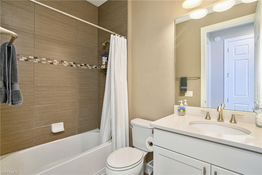 20111 Torch Key Way Estero, FL 33928 - Photo 9 of 29 a bathroom with a sink toilet and shower
