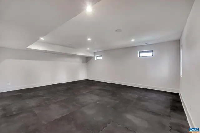 an empty room with a empty space and windows